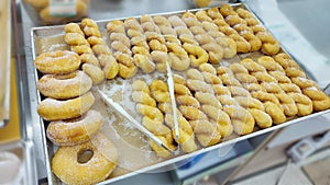 Delicious Daily twist sugar donuts on a tray.