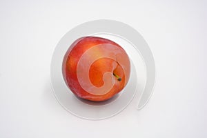 Delicious useful fruits, red, cherry ripe plums located on a white background.