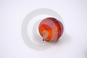 Delicious useful fruits, red, cherry ripe plums located on a white background.