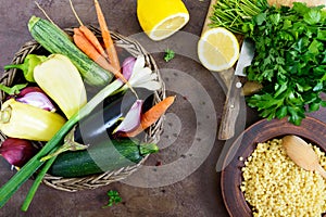 Delicious useful porridge cous cous in a clay plate and raw fresh vegetables in a basket