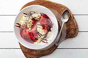 Delicious vanilla ice cream with raspberry sauce