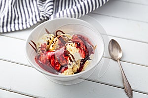 Delicious vanilla ice cream with raspberry sauce