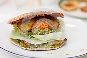 Delicious vegan burger on white plate