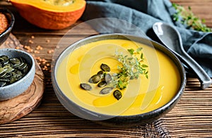 Delicious vegan creamy red lentil and pumpkin soup topped with fresh thyme