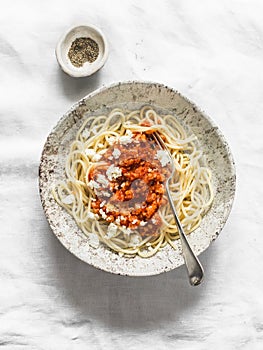 Delicious vegetarian cauliflower cabbage bolognese sauce with spaghetti on light background, top view. Healthy diet food concept