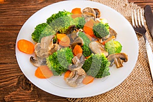 Delicious vegetarian food in a dish vegetable meal. Broccoli, carrots and mushrooms