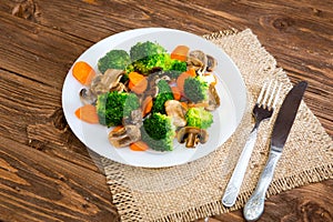 Delicious vegetarian food in a dish vegetable meal. Broccoli, carrots and mushrooms