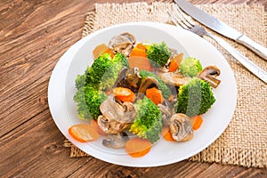 Delicious vegetarian food in a dish vegetable meal. Broccoli, carrots and mushrooms