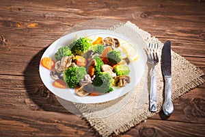 Delicious vegetarian food in a dish vegetable meal. Broccoli, carrots and mushrooms