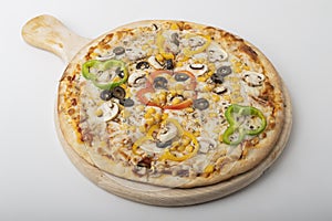 Delicious Vegetarian pizza served on wooden plate 
