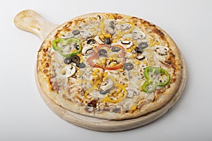 Delicious Vegetarian pizza served on wooden plate