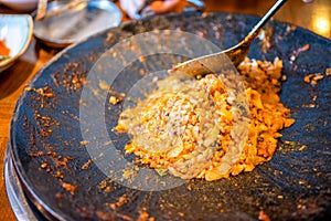 Delicious volcanic shaped fried rice with egg and spicy sauce, pork and squid, famous south korean food in jeju island restaurant