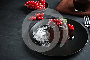 Delicious warm chocolate lava cake with mint and berries on table photo
