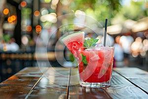 Delicious watermelon cocktail in glass on cafe table, evoking summer vibes and refreshment