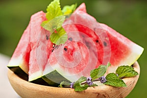 Delicious watermelon slices on wooden plate