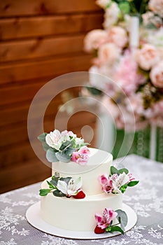 Delicious wedding cake decorated white icing with exotic flowers