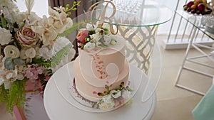 Delicious wedding cake with two floors decorated with details, roses and topper