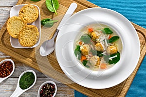 Delicious wedding soup with meatball, carrots and spinach