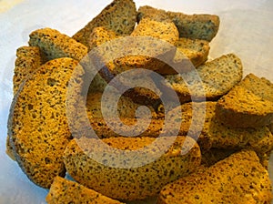 Delicious wheat crouton with poppy seeds. Toast for tea or coffee. Dried sliced bread in oven. Bon Appetit. Cheap food. Cut out th