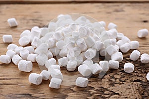 Delicious white marshmallows on wooden table, closeup