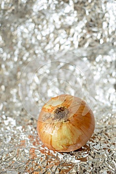 a delicious white onion over a tin paper