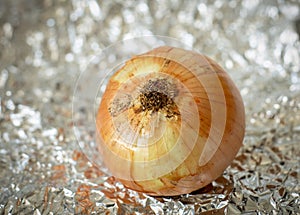 a delicious white onion over a tin paper