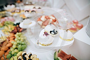 Delicious white wedding reception candy bar dessert table