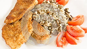 Delicious Wiener Schnitzel with lemon and tomatoes