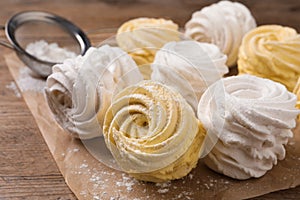 Delicious yellow and white marshmallows on wooden table, closeup