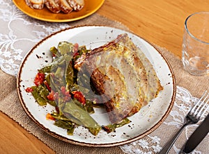 Deliciously cooked pork ribs with stewed green beans close up