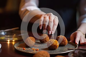 Deliciously Crafted: Woman's Hands Making Irresistible Spanish Croquettes