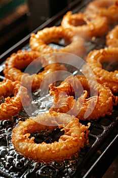 Deliciously fried calamari rings golden, crispy, and tender perfection achieved in oil photo
