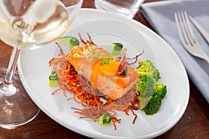 Deliciously steak of fried salmon with smoked carrots, broccoli and fig