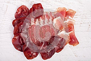 Delicoius italian ham on wooden background
