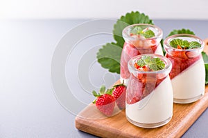 Delicous and nutritious double color colour strawberry desserts with mint and diced sarcocarp topping  with airy blue