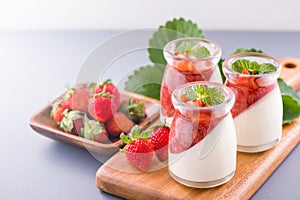 Delicous and nutritious double color colour strawberry desserts with mint and diced sarcocarp topping  with airy blue