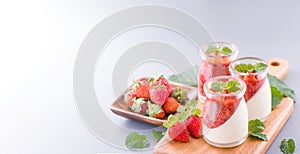 Delicous and nutritious double color colour strawberry desserts with mint and diced sarcocarp topping  with airy blue