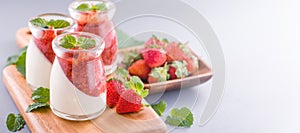 Delicous and nutritious double color colour strawberry desserts with mint and diced sarcocarp topping  with airy blue