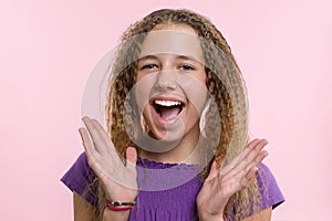 Delight, happiness, joy, victory, success and luck. Teen girl on a pink background. Facial expressions and people emotions concept