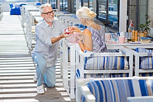 Delighted aged woman looking at the engagement ring photo