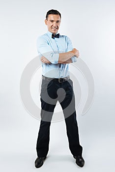 Delighted attractive man crossing his arms