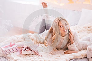 Delighted blonde woman having a phone conversation