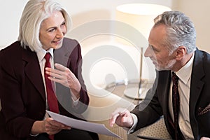 Delighted businesswoman discussing the project with her colleague