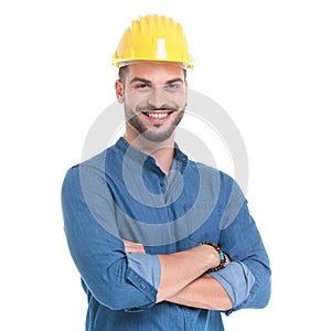 Delighted casual man smiling with his arms crossed