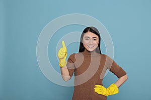 Delighted cheerful asian houseworker thumb up from chores