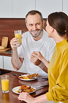 delighted child-free couple holding hands