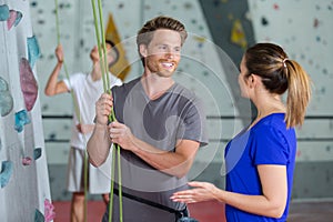 delighted couple climbing up wall