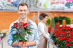 Delighted customer holding a flower