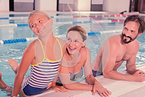 Delighted cute girl being in the pool