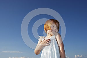 Delighted Cute Girl Looking Away Against Blue Sky